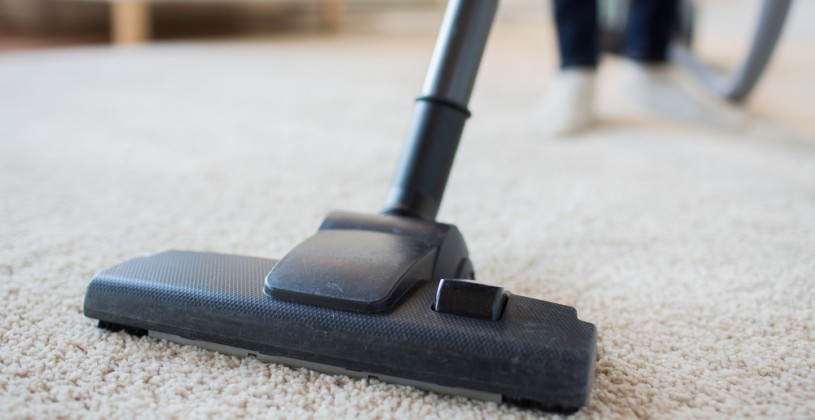close up of a stick vacuum on a rug