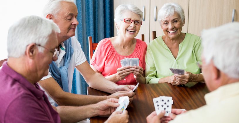 Five seniors enjoying a game of cards. Playing games is just one way to exercise your brain.
