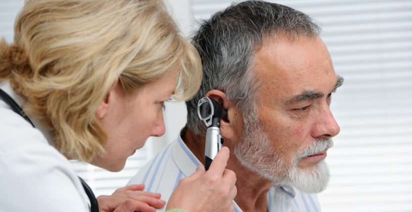 Doctor examines a senior patient’s ear. It’s important to address any hearing impairment as soon as possible
