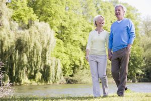 Senior couple strolling outdoors on a spring day. Staying physically active through the years is an important key to overall well-being and longevity.