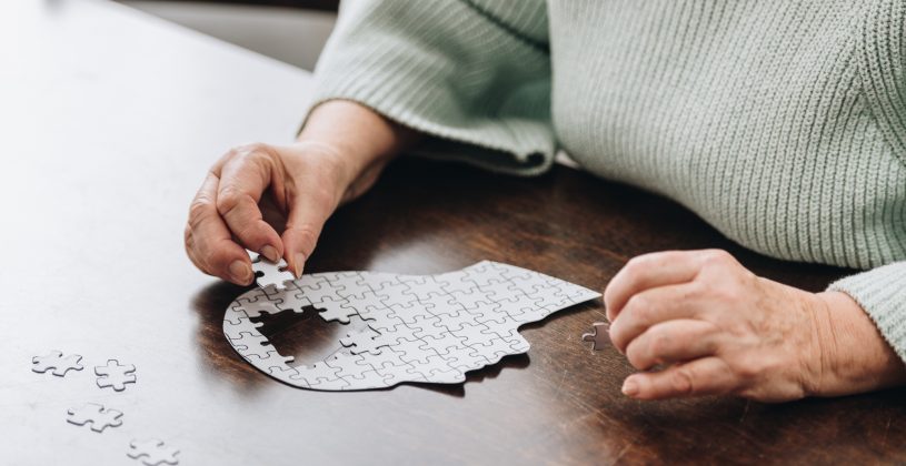 Senior woman doing a puzzle. Dementia is a medical condition that affects roughly 50 million people throughout the world.