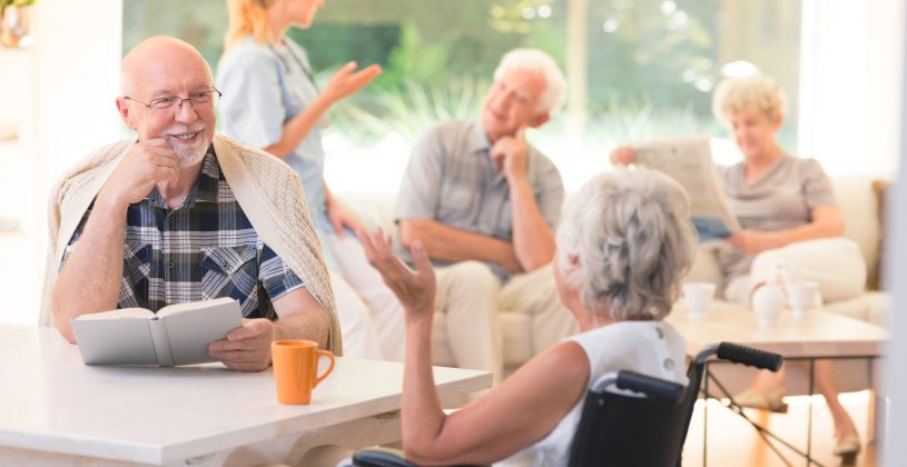 Residents of a senior living community, chatting over coffee and tea.