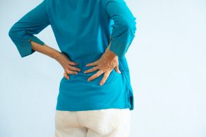 Senior woman with kidney pain in lower back.